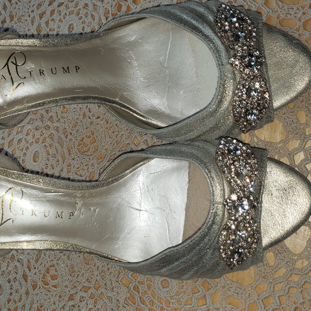 This is a pair of Ivanka Trump Nanci d'Orsay peep-toe pumps silver 7.5